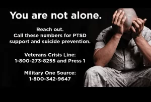 Thank you for your service! Image of a distraught soldier on a banner with phone numbers to reach out to for mental health counseling.